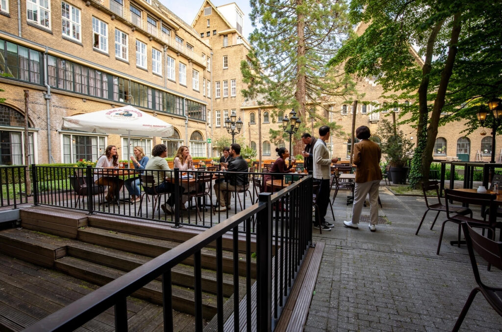 Gasten op het terras in de groene binnentuin van Loetje Leiden.
