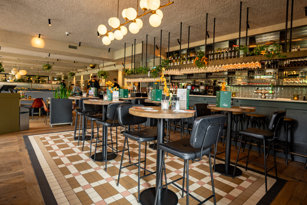 Bar en hoge tafels in het sfeervolle interieur van Loetje Rotterdam Blaak.